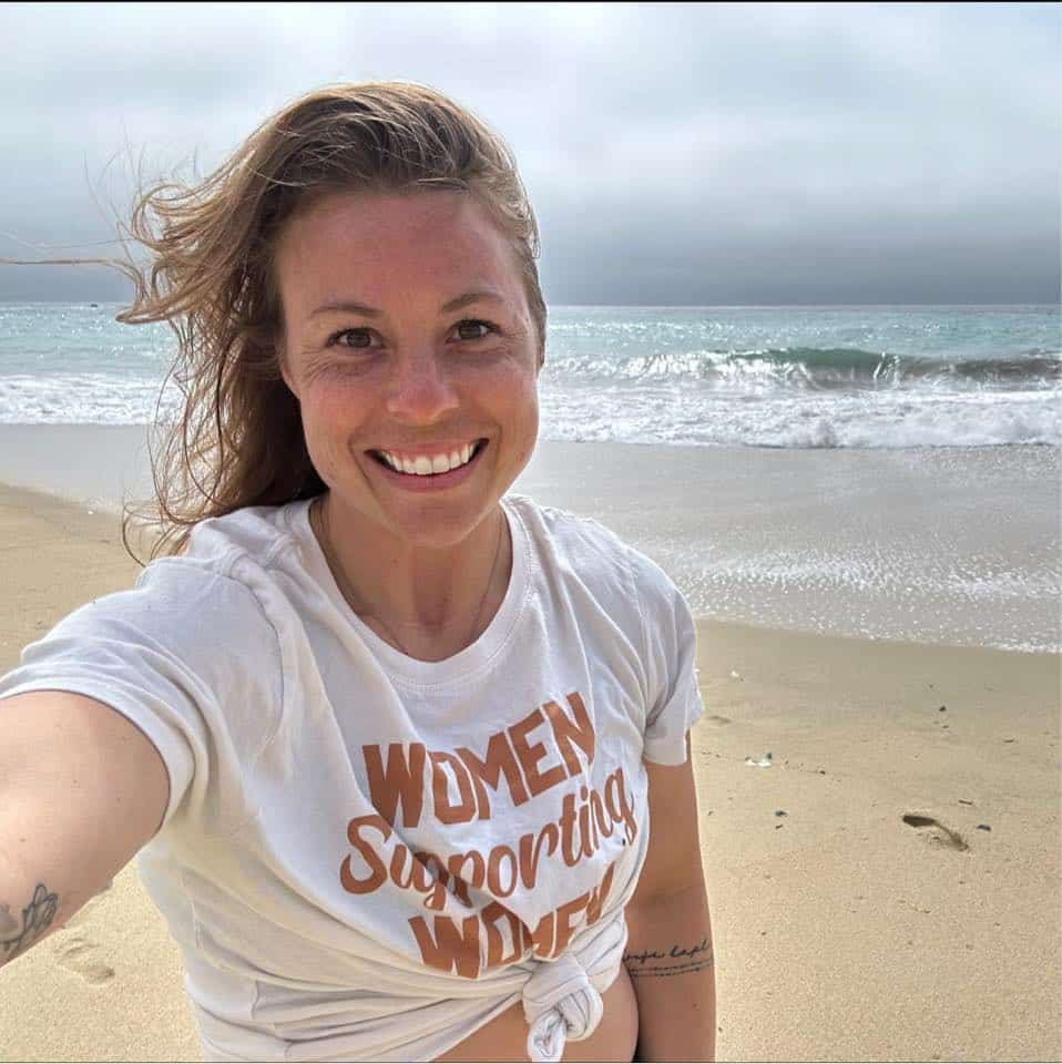 Woman standing on the beach smiling